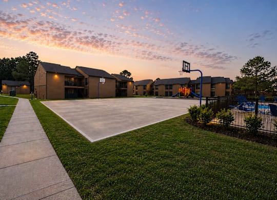 Basketball court and playground at sunset at Ridgeview Apartments, Sherman, Texas