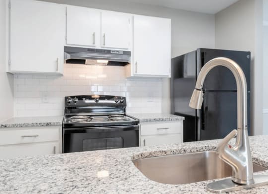 a kitchen with granite counter tops and a sink  at Henley, North Carolina