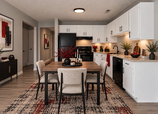 A modern kitchen with a dining table set for four.