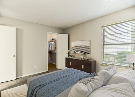a bedroom with a bed and a dresser and a window