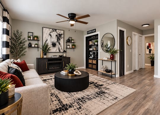 A living room with a fireplace, a couch, and a rug.