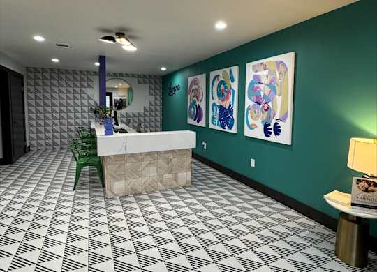 A reception area with a white reception desk and a green chair.