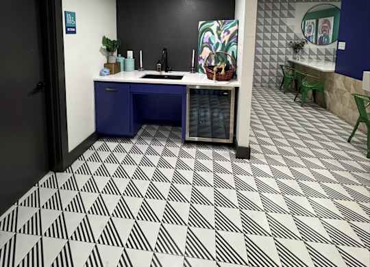 A bathroom with a black and white tiled floor.