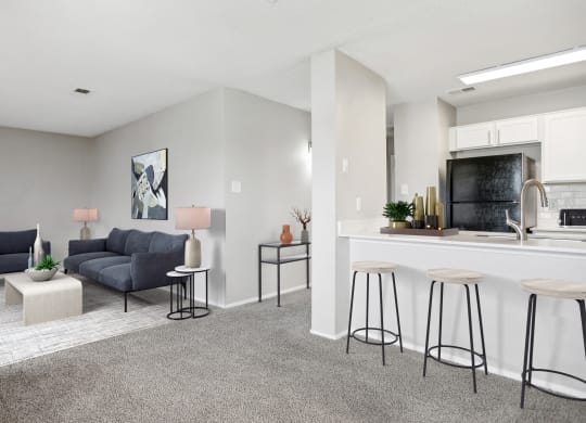 an open living room and kitchen with a bar and a couch