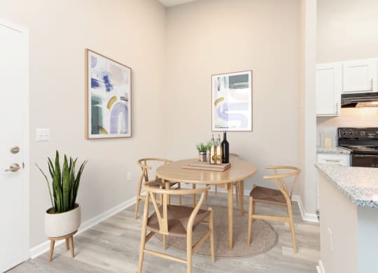 a dining room with a table and chairs and a kitchen