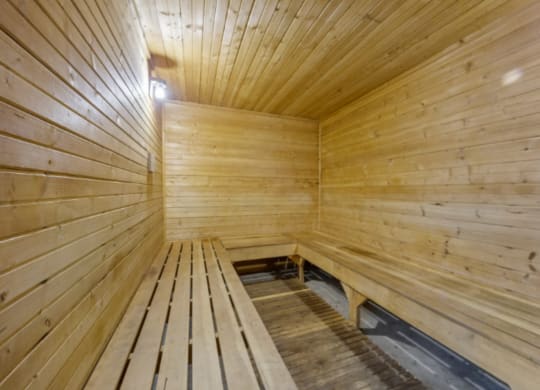a sauna with wooden walls and wooden benches