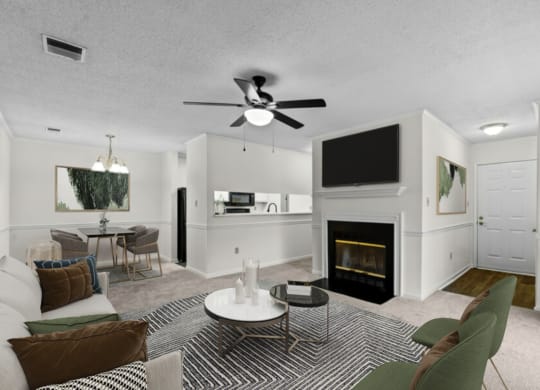 a living room with a fireplace and a ceiling fan
