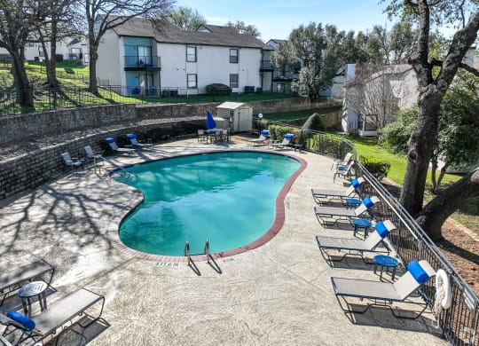 an aerial view of a swimming pool with lounge chairs around it  at Shadow Ridge, Arlington, 76013