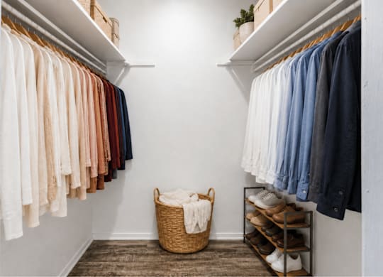 Walk-in closet with organized hanging rods and shelving at Ridgeview Apartments, Texas, 75092