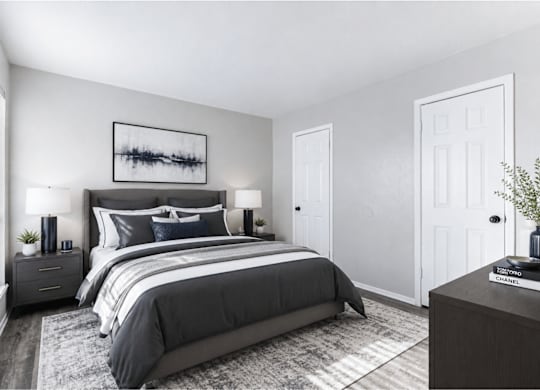 Modern bedroom with dark furniture and neutral decor at Ridgeview Apartments, Sherman, TX