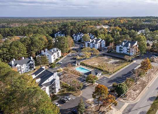 an aerial view of a neighborhood with houses and a road