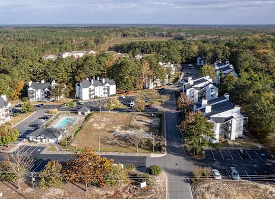 a aerial view of a neighborhood with houses and a swimming pool