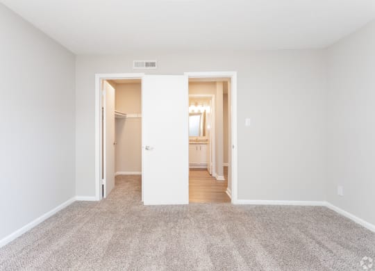 an empty living room with white walls and carpet