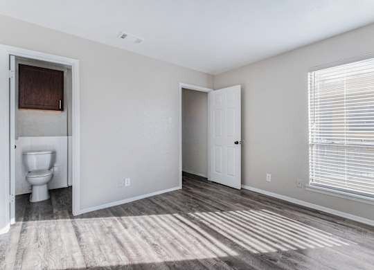 Unfurnished bedroom with private bathroom access at Ridgeview Apartments, Sherman, TX 75092