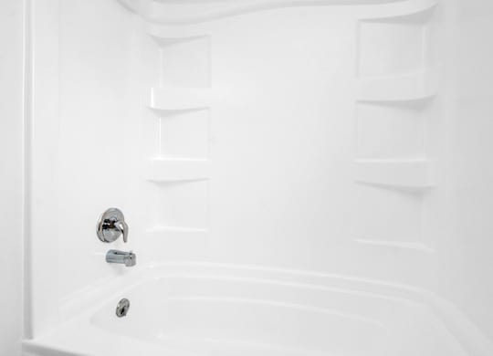 a white bathroom with a shower and a sink