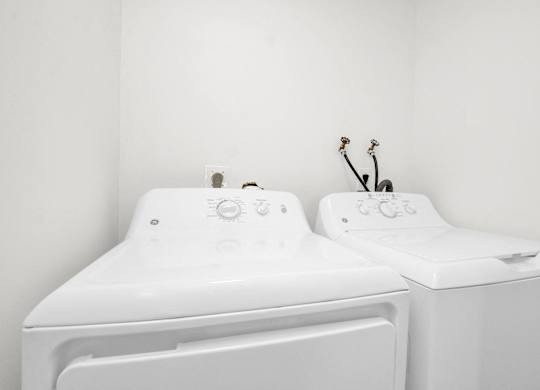 the laundry room has two washes and a dryer