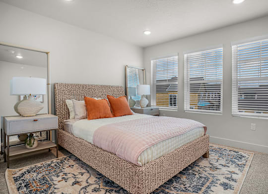 A bedroom with a large bed and a mirror on the wall.