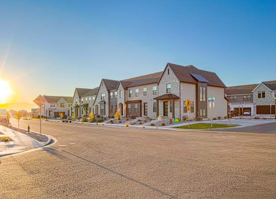 A sunny day in a residential neighborhood with houses and a street.