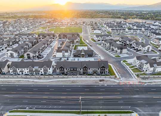 A sunset view of a residential neighborhood with houses and streets.