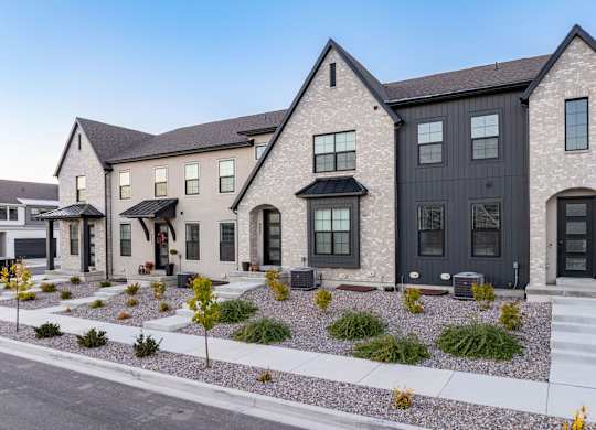 A modern house with a black door and windows.