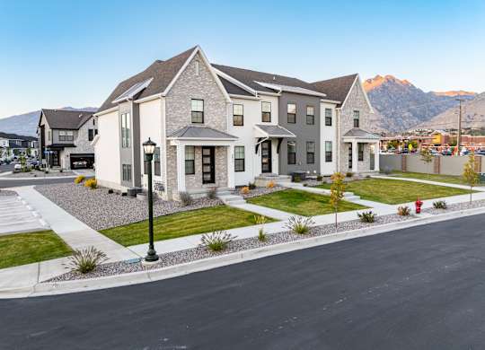 A large house with a mountain in the background.