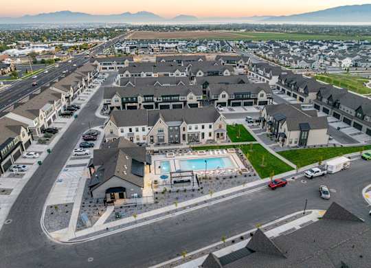 A large residential complex with a swimming pool in the center.