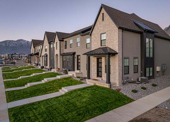 A row of houses with a mountain in the background.