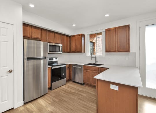 a kitchen with stainless steel appliances and wooden cabinets