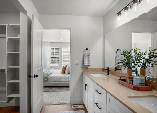 A bathroom with a white door and a white sink.