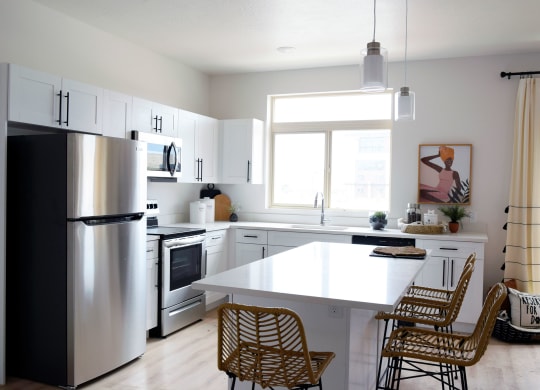a kitchen with white cabinets and a white counter top