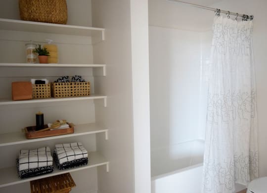 a bathroom with white walls and a white shower curtain
