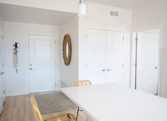 a dining room with a white table and yellow chairs
