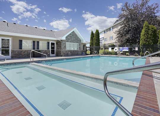 A swimming pool with a metal ladder in the middle.