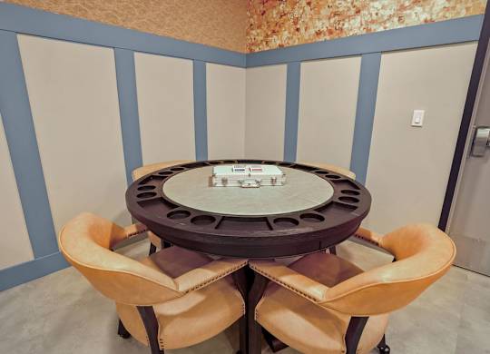 A round table with four chairs around it.