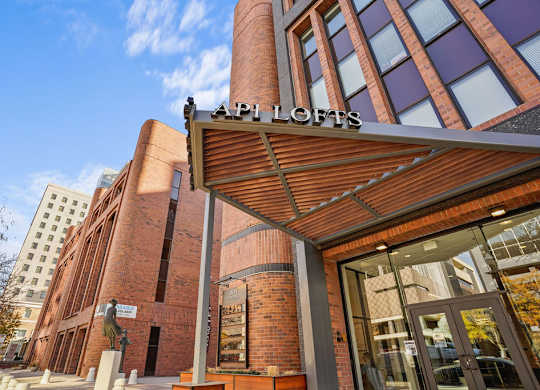 A modern building with a red brick facade and a glass entrance.