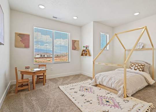 a bedroom with a bed and a desk