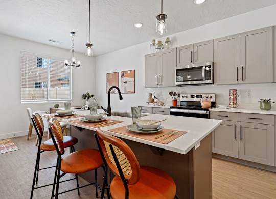 an open kitchen and dining area with a table and chairs