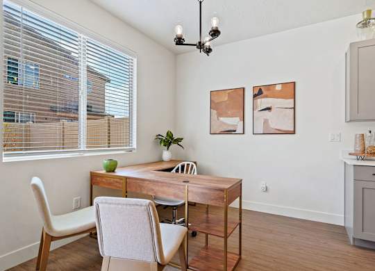 a dining room with a table and chairs and a window