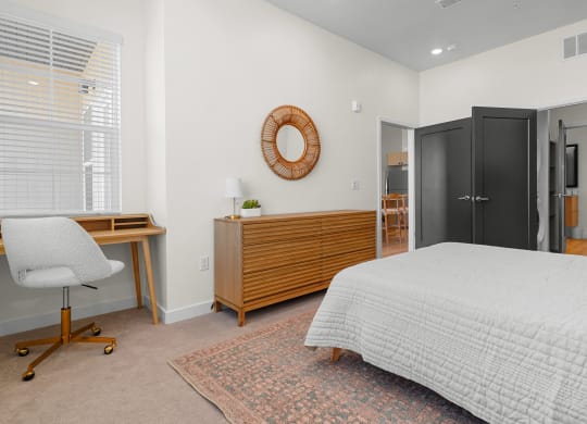 a furnished bedroom with a dresser