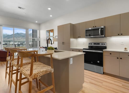 a furnished kitchen with stools