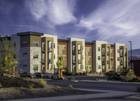 an exterior view of an apartment building on a city street