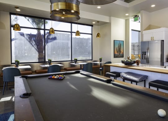 a communal area with a pool table and a bar