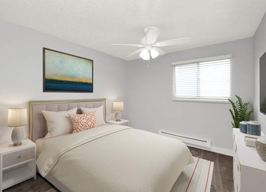 A bedroom with a large bed, a ceiling fan, and a painting on the wall.