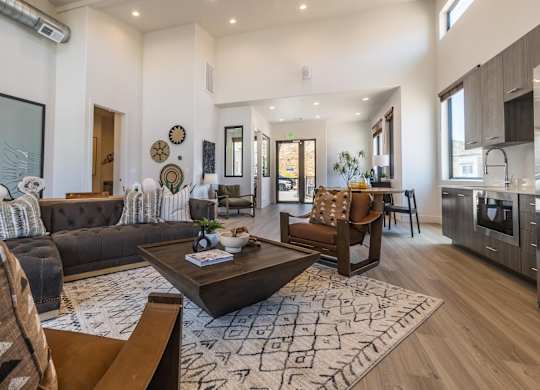 A modern living room with a dark brown sofa and a wooden coffee table.