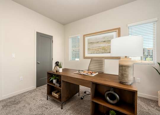 A room with a desk and chair in it.