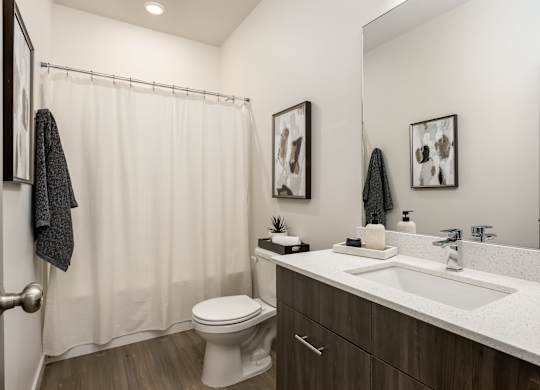A bathroom with a white toilet and a white sink.