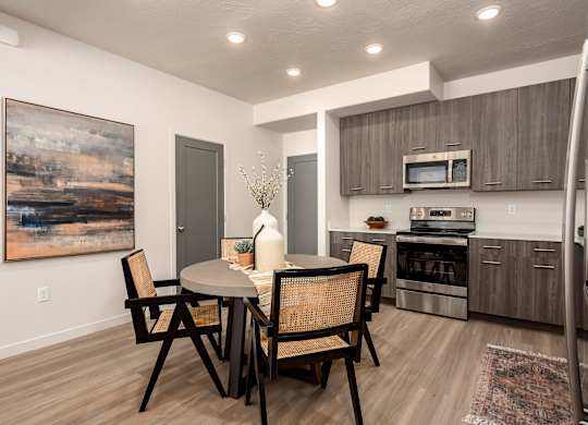 A modern dining room with a table set for two.
