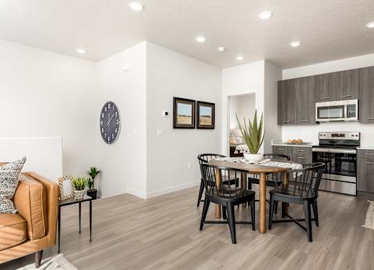 A modern kitchen with a dining table and chairs.