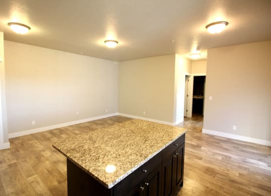 an empty living room with a kitchen island