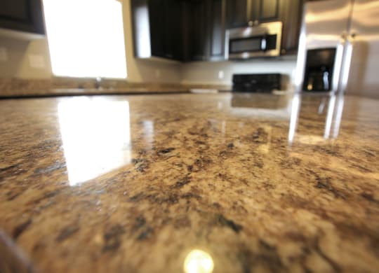 a closeup of a granite countertop in a kitchen